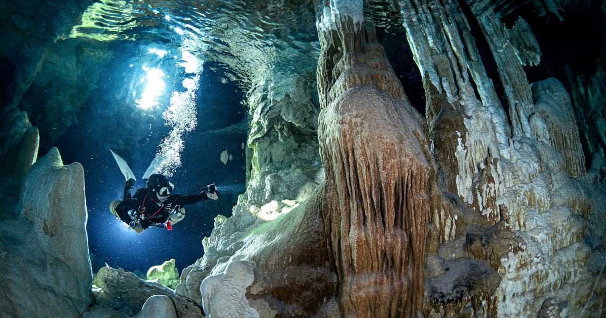 Kim Delnegro diving in underwater cave