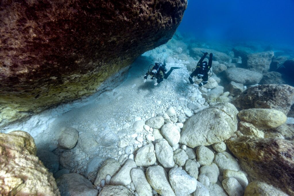 two scuba divers diving with their Hollis buoyancy control devices